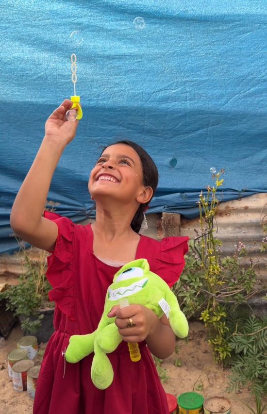 Batoul playing with bubbles in Gaza
